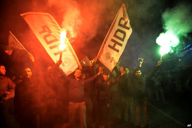 People's Democratic Party supporters (HDP) celebrate after the announcement of preliminary results of the local elections, in Diyarbakir, Turkey, Sunday, March 31, 2019.