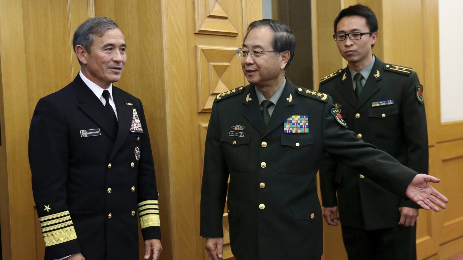 U.S. Navy Admiral Harry B. Harris, Jr., Commander U.S. Pacific Command (L) is shown the way by China's PLA Chief of Staff General Fang Fenghui (C) as they proceed to their meeting at the Bayi Building in Beijing, China, Nov. 3, 2015.