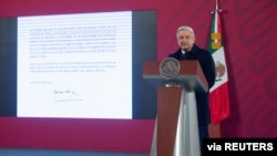 Mexico's President Andres Manuel Lopez Obrador speaks as a screen displays the letter he sent to U.S. President-elect Joe Biden during a news conference at the National Palace, in Mexico City, Mexico, Dec. 15, 2020.