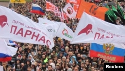 People attend a rally to demand the release of jailed protesters, who were detained during opposition demonstrations for fair elections, in Moscow, Sept. 29, 2019.