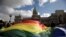 FILE - In this July 14, 2010 file photo, demonstrators wave a gay pride flag outside Congress in support of a proposal to legalize same-sex marriage in Buenos Aires. 