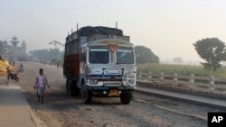 A man walks near a truck at Birgunj, a town on the border with India, Nepal, Monday, Nov. 2, 2015.