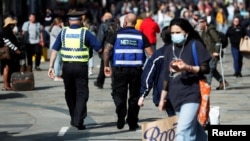 A street ranger and a police community support officer patrol Northumberland Street amid the spread of the coronavirus disease, in Newcastle, Britain, Sept. 18, 2020. 