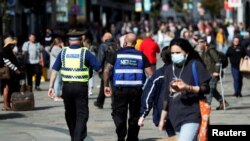 A street ranger and a police community support officer patrol Northumberland Street amid the spread of the coronavirus disease, in Newcastle, Britain, Sept. 18, 2020. 