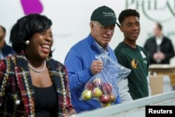 FILE - U.S. President Joe Biden volunteers at Philabundance, a hunger relief organization, with Mayor of Philadelphia Cherelle Parker, in observance of the MLK Day of Service in Philadelphia, Pennsylvania, January 15, 2024.