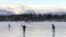 FILE - Ice skaters take advantage of unseasonable warm temperatures to ice skate outside at Westchester Lagoon in Anchorage, Alaska, Jan. 2, 2018. While a large part of the county is freezing under Alaska-like conditions, parts of the nation's northernmost state were basking in balmy conditions.