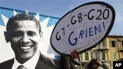 Demonstrator with a placard that reads 'G7-G8-G20-I have nothing' during a protest in Nice, France, Nov. 1, 2011.