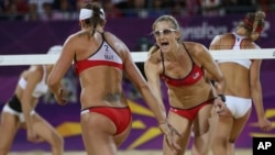 FILE - The United States' Kerri Walsh Jennings, right, and Misty May-Treanor react during the women's gold medal beach volleyball match against another U.S. team at the 2012 Summer Olympics, Aug. 8, 2012, in London.