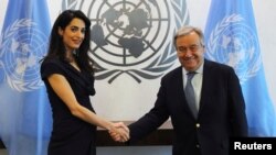 International human rights lawyer Amal Clooney shakes hands with United Nations Secretary General, Antonio Guterres, at U.N. headquarters in New York, March 10, 2017. 