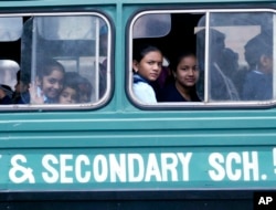FILE - Kenyan students ride a school bus in Nairobi. In villages in the country's northeast, teachers are fleeing out of fear of al-Shabab militants.