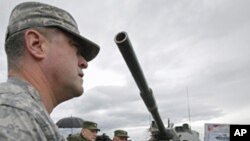 A US, OSCE military observer examines a newly added to Russia's armory 2S25 "Sprut-SD" heavy armament combat vehicle, Sept. 23, 2011.