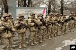 This handout photo taken and released by the Russian Defense Ministry January 12, 2022, shows Armenian soldiers CSTO soldiers guarding an infrastructure facility in Almaty, Kazakhstan.