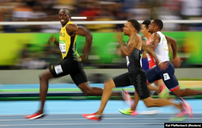 Jamaican sprinter Usain Bolt (in the lead) looks at the camera as he and other runners compete at the 2016 Olympics in Rio de Janeiro, Brazil. (Reuters Photo: Kai Pfaffenbach)