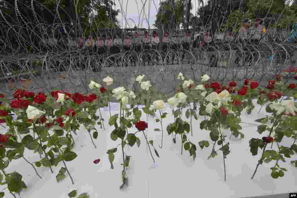 Indonesian policemen stand guard behind barbed wire and roses during the verdict for Jakarta governor Basuki Tjahaja Purnama outside the North Jakarta court.