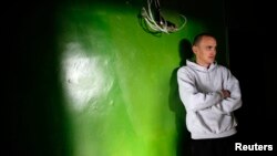 Bulgarian Alexander Angelov, 27, looks on as he stands outside his apartment in a block in the town of Vratsa, some 110km (68 miles) north of Sofia, Apri. 10, 2013.