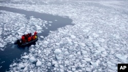 FILE - In this Jan. 22, 2015 photo, a zodiac carrying a team of international scientists heads to Chile's station Bernardo O'Higgins, Antarctica. Water is eating away at the Antarctic ice, melting it where it hits the oceans. (AP Photo/Natacha Pisarenko)