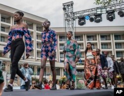 FILE - Models present dresses during the ninth edition of the Liputa fashion show in Goma, Democratic Republic of Congo, Saturday June 24, 2023.