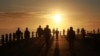 People exercise at sunrise in Sea Point, Cape Town, South Africa as the country marks day 53 of a government lockdown in a bid to prevent the spread of coronavirus.