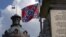 The U.S. flag and South Carolina state flag flies at half staff to honor the nine people killed in the Charleston murders as the confederate battle flag also flies on the grounds of the South Carolina State House in Columbia, SC, June 20, 2015.