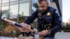 FILE - Metropolitan Police Department Sgt. Anthony Walsh sets out steering wheel locks at an anti-crime event in Washington on Nov. 7, 2023. A physical lock that attaches to the steering wheel can act as a visible deterrent to car thieves. (AP Photo/Amanda Andrade-Rhoades, File)