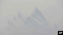 Thick smoke from wildfires shroud the Opera House in Sydney, Australia, Dec. 10, 2019. 