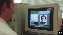FILE - An operator at a CD-ROM production company inputs information on July 16, 1996 about Soviet Spy Kim Philby.