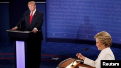 Republican presidential nominee Donald Trump listens as Democratic presidential nominee Hillary Clinton speaks during their third and final 2016 presidential campaign debate at UNLV in Las Vegas, Oct. 19, 2016. 