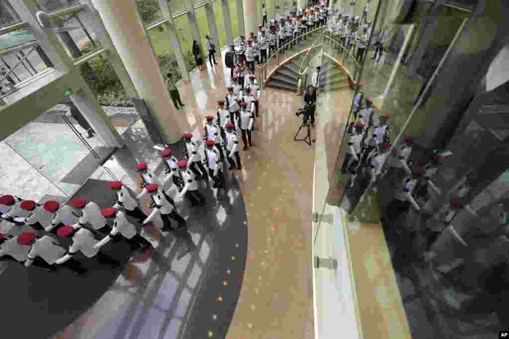 The honor guard and military band march into position at the state funeral for the late Lee Kuan Yew, at the University Cultural Center, March 29, 2015.