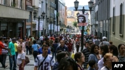 People walk along a pedestrian street in Caracas, Venezuela, Nov. 2, 2017.