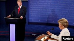 Republican presidential nominee Donald Trump listens as Democratic presidential nominee Hillary Clinton speaks during their third and final 2016 presidential campaign debate at UNLV in Las Vegas, Oct. 19, 2016. 