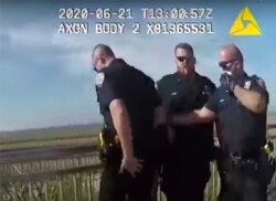 FILE - In this photo taken from police body cam video, New York Police officers, including officer David Afanador, right, arrest a man on a boardwalk in New York's Rockaway Beach, June 21, 2020.