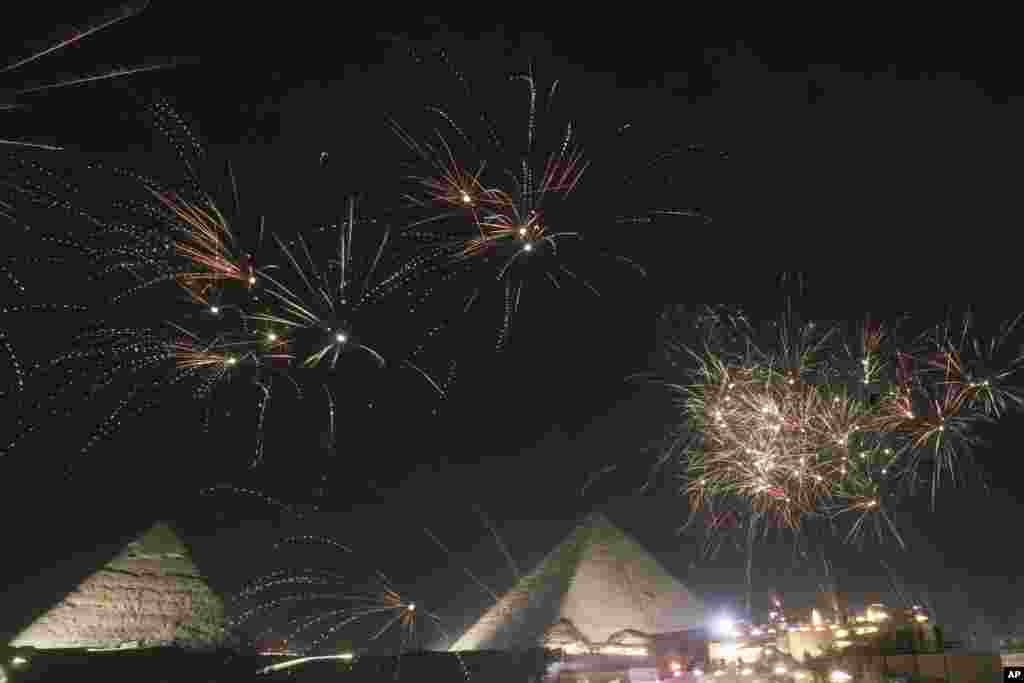 Fireworks spark over the historical site of Giza Pyramids, marking the new year, just outside Cairo, Egypt, Jan. 1, 2025. 