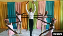 Anthony Mmesoma Madu, 11 anos, bailarino nigeriano, rodeado de bailarinas na escola Leap of Dance Academy, em Lagos