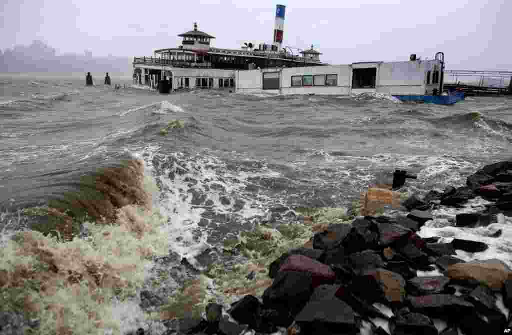 An historic ferry boat named the Binghamton is swamped by the waves on the Hudson River in Edgewater, N.J., Monday, Oct. 29, 2012 as Hurricane Sandy lashed the East Coast.