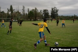 Amateur soccer players from the Chivas team play on a field in the Xochimilco borough of Mexico City, on Sunday, October 20, 2024. (AP Photo/Felix Marquez)