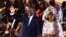 Le président sortant Macky Sall (à gauche) et son épouse Marieme Faye Sall (à droite) saluent les spectateurs à la cérémonie de son investiture comme candidat à la prochaine élection présidentielle, à Dakar,  le 1er décembre 2018,