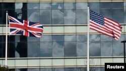 FILE - A British Union flag (L) and U.S. flag are seen flying in front of an office building in London, March 30, 2016. Post-Brexit relations between the two countries have been a matter of debate.