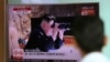 A man watches a TV screen showing a local news program reporting about North Korea's missile firing with an image of North Korean leader Kim Jong Un with a pair of binoculars, at Seoul Train Station in Seoul, South Korea, July 5, 2017.