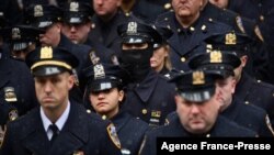 New York police officers gather outside St. Patrick's Cathedral for the funeral of Officer Jason Rivera in New York, Jan. 28, 2022. Rivera and his partner, Officer Wilbert Mora, were fatally wounded when a gunman ambushed them as they responded to a family dispute last week.