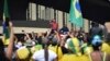 Brazil's President Jair Bolsonaro, center, speaks to supporters during a protest in front the army's headquarters during the Army day, amid the new coronavirus pandemic, in Brasilia, Brazil, April 19, 2020.