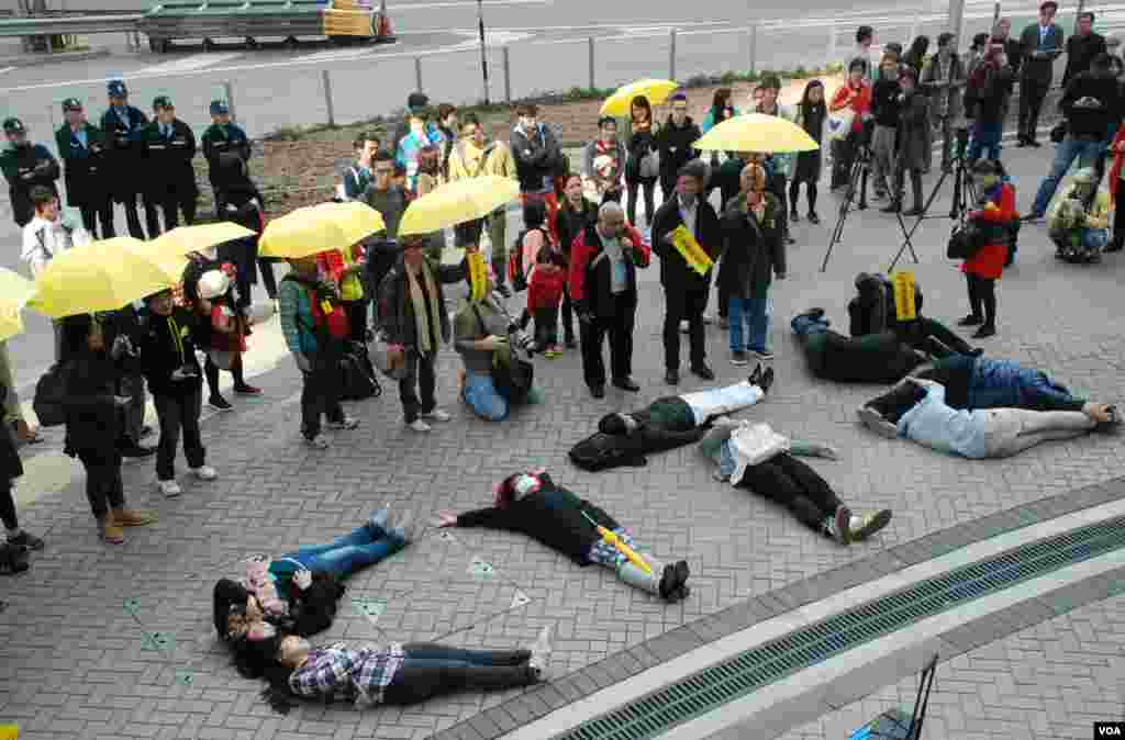 几名元旦日参与声援14岁涂鸦少女的集会人士，躺在地上拼出"CY下台"，即是特首梁振英下台的字样