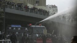 Protesters calling themselves the "Youth of March 24 Movement" demonstrate to demand for political reform and the ouster of the prime minister in front of police water canons at a main square in Amman, March 25, 2011