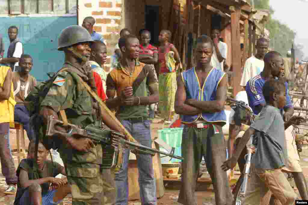 DRC soldiers, part of an African peacekeeping force, patrol along a street in Bangui, Feb. 12, 2014. 