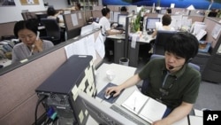 AhnLab Inc Customer Support team talk to customers on their phones at a call center in Seoul (file photo)