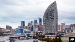FILE - What was intended to be the Trump International Hotel, the highest building, is seen in Baku, Azerbaijan, Feb. 19, 2016. The Trump Organization canceled its licensing deal for the planned hotel in December 2016, one month after Donald Trump was elected U.S. president.