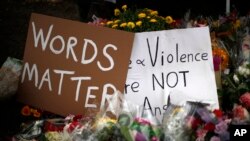 Flowers surround signs on Oct. 31, 2018, part of a makeshift memorial outside the Tree of Life synagogue to the 11 people killed during worship services Oct. 27, 2018, in Pittsburgh.