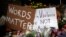 Flowers surround signs on Oct. 31, 2018, part of a makeshift memorial outside the Tree of Life synagogue to the 11 people killed during worship services Oct. 27, 2018, in Pittsburgh.