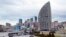 FILE - What was intended to be the Trump International Hotel, the highest building, is seen in Baku, Azerbaijan, Feb. 19, 2016. The Trump Organization canceled its licensing deal for the planned hotel in December 2016, one month after Donald Trump was elected U.S. president.