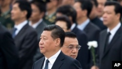 FILE - Chinese President Xi Jinping arrives at the Monument to the People's Heroes during a ceremony marking Martyr’s Day at Tiananmen Square in Beijing, China, Sept. 30, 2014. (AP Photo/Andy Wong) 