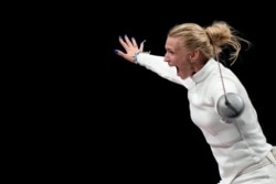 Katrina Lehis of Estonia celebrates after winning the Women's Epee team final at the 2020 Summer Olympics, July 27, 2021, in Chiba, Japan.